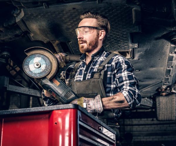 mechanic-in-protective-googles-holds-angle-grinder-small.jpg